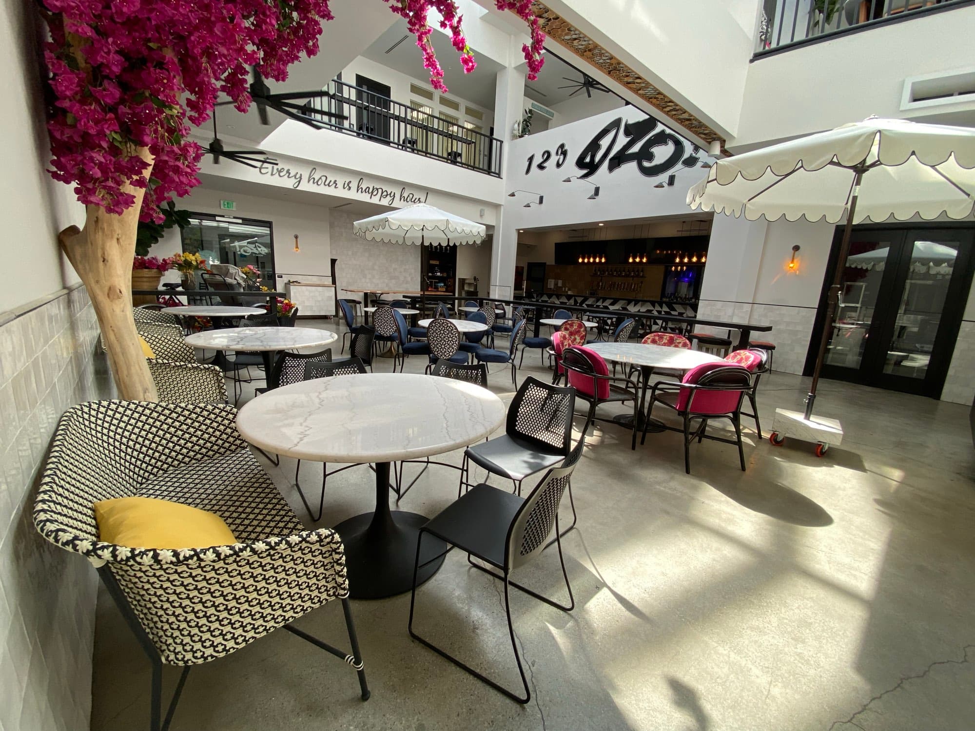 Marble tables under the umbrellas in the Atrium